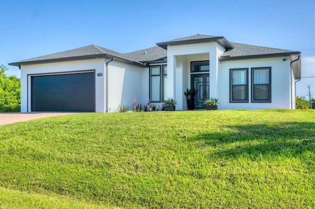 10270 Castanet Ave, Englewood, FL 34224 - prairie-style home with an attached garage, stucco siding, a front yard, driveway, and a shingled roof