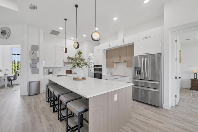 10270 Castanet Ave, Englewood, FL 34224 - kitchen featuring stainless steel appliances, modern cabinets, light wood-type flooring, a large island, and recessed lighting