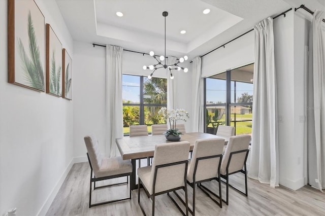 10270 Castanet Ave, Englewood, FL 34224 - dining area featuring a chandelier, a tray ceiling, light wood-style flooring, and recessed lighting