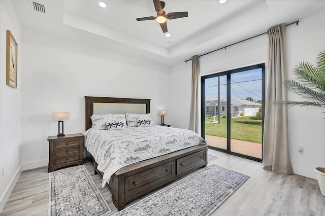 10270 Castanet Ave, Englewood, FL 34224 - bedroom featuring access to outside, light wood-style flooring, a tray ceiling, recessed lighting, and a ceiling fan
