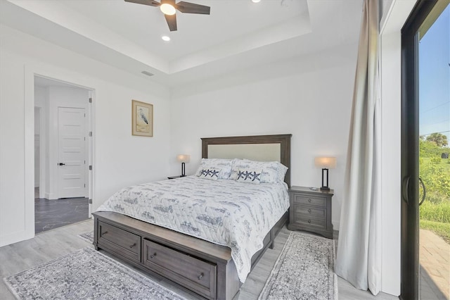 10270 Castanet Ave, Englewood, FL 34224 - bedroom featuring light wood-style flooring, recessed lighting, a tray ceiling, and a ceiling fan