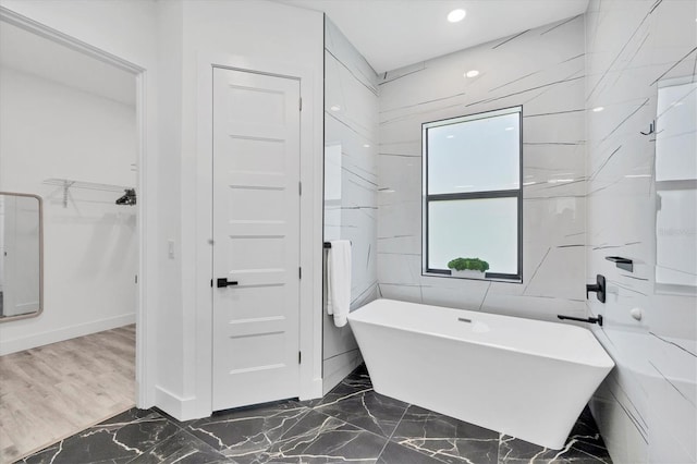 10270 Castanet Ave, Englewood, FL 34224 - full bath with a soaking tub, marble tiled floors, a spacious closet, and recessed lighting
