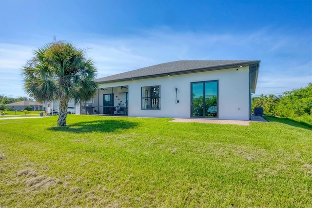 10270 Castanet Ave, Englewood, FL 34224 - back of house with a lawn, stucco siding, and a ceiling fan