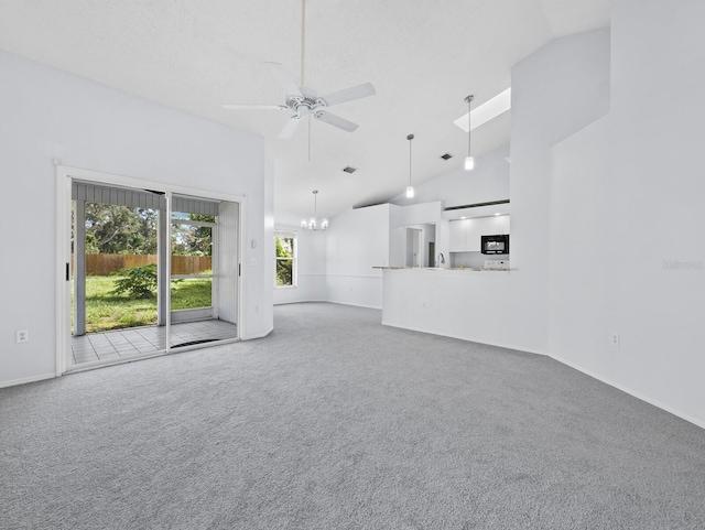 3223 Jamaica St, Sarasota, FL 34231 - unfurnished living room featuring ceiling fan, carpet flooring, a chandelier, and high vaulted ceiling
