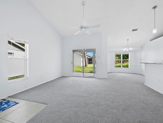 3223 Jamaica St, Sarasota, FL 34231 - unfurnished living room with carpet floors, a chandelier, ceiling fan, and vaulted ceiling