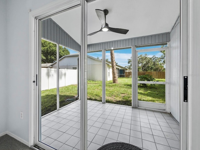 3223 Jamaica St, Sarasota, FL 34231 - doorway with a ceiling fan and light tile patterned flooring