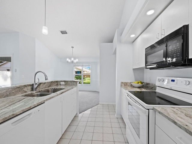 3223 Jamaica St, Sarasota, FL 34231 - kitchen featuring white appliances, light carpet, white cabinets, hanging light fixtures, and recessed lighting