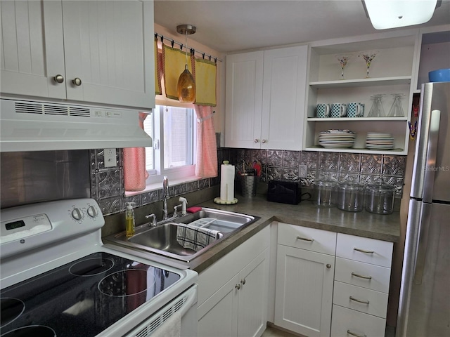 5850 Welcome Rd Unit J6, Bradenton, FL 34207 - kitchen featuring white range with electric stovetop, freestanding refrigerator, under cabinet range hood, backsplash, and white cabinets