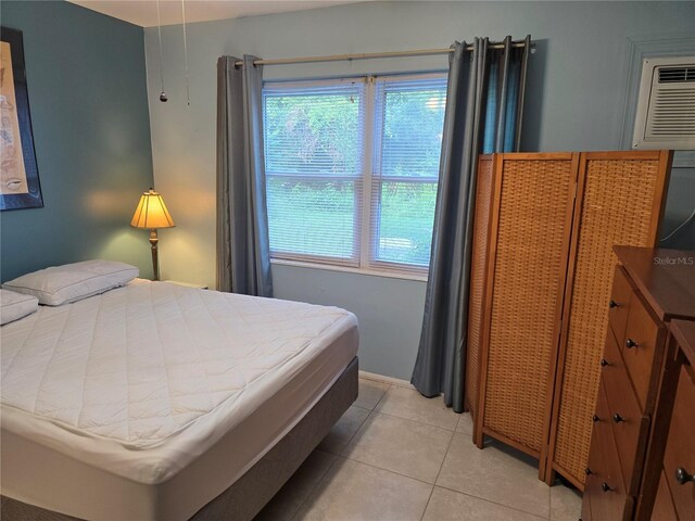 5850 Welcome Rd Unit J6, Bradenton, FL 34207 - bedroom with light tile patterned flooring and a wall mounted air conditioner