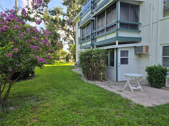 5850 Welcome Rd Unit J6, Bradenton, FL 34207 - view of grassy yard featuring a patio area and a wall unit AC