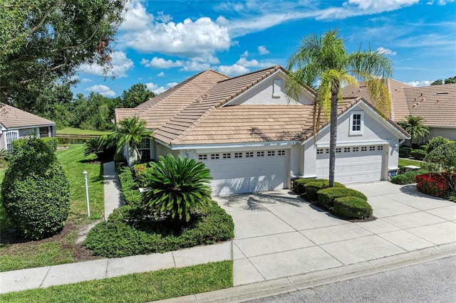 7039 Woodmore Ter, Lakewood Ranch, FL 34202 - traditional-style home featuring a garage, concrete driveway, stucco siding, and a tile roof