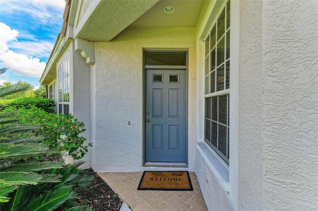 7039 Woodmore Ter, Lakewood Ranch, FL 34202 - doorway to property featuring stucco siding
