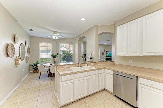 7039 Woodmore Ter, Lakewood Ranch, FL 34202 - kitchen featuring dishwasher, a ceiling fan, light tile patterned floors, arched walkways, and light countertops