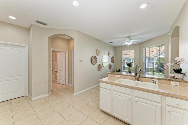 7039 Woodmore Ter, Lakewood Ranch, FL 34202 - kitchen featuring arched walkways, ceiling fan, light countertops, recessed lighting, and light tile patterned flooring