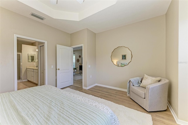 7039 Woodmore Ter, Lakewood Ranch, FL 34202 - bedroom featuring light wood finished floors and ensuite bathroom