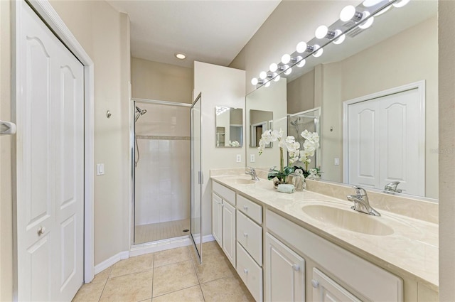 7039 Woodmore Ter, Lakewood Ranch, FL 34202 - bathroom with double vanity, tile patterned floors, and a stall shower