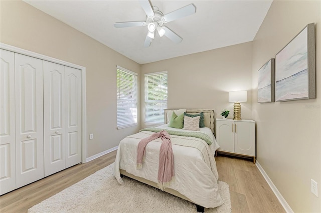 7039 Woodmore Ter, Lakewood Ranch, FL 34202 - bedroom with light wood finished floors, a closet, and ceiling fan