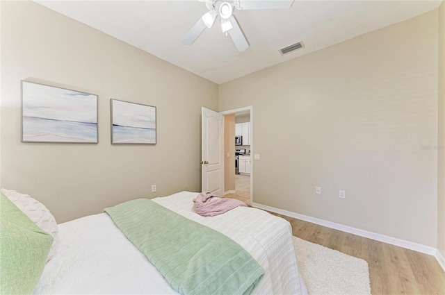 7039 Woodmore Ter, Lakewood Ranch, FL 34202 - bedroom with light wood-style floors and a ceiling fan