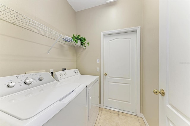 7039 Woodmore Ter, Lakewood Ranch, FL 34202 - laundry room featuring washer and dryer and light tile patterned flooring