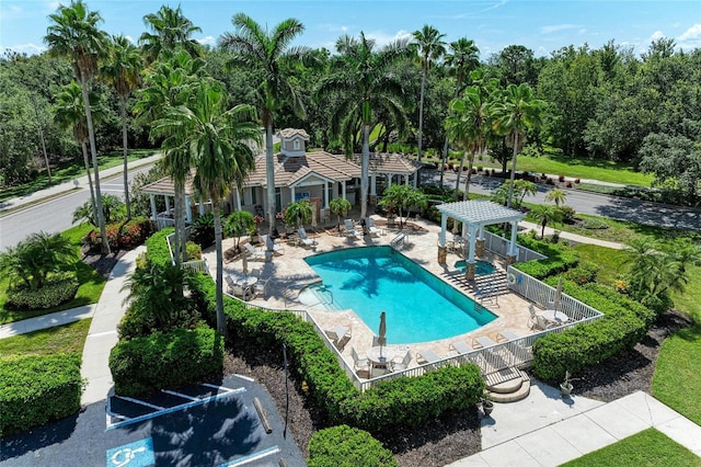 7039 Woodmore Ter, Lakewood Ranch, FL 34202 - community pool featuring a pergola, a patio, and view of scattered trees
