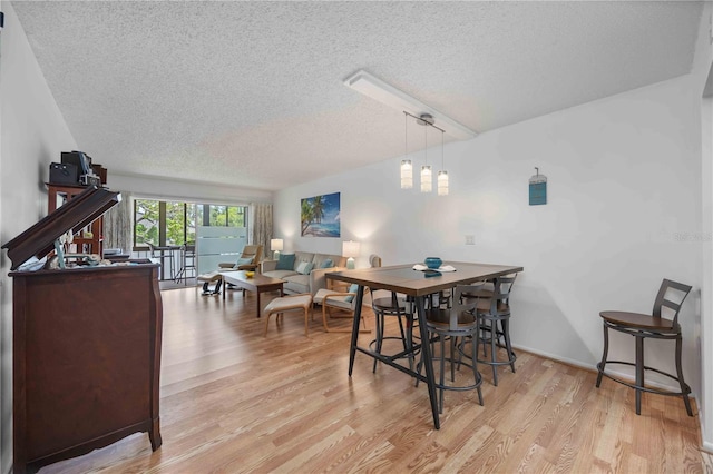 2220 Stickney Point Rd Unit 528, Sarasota, FL 34231 - dining room with a textured ceiling and light wood-style floors