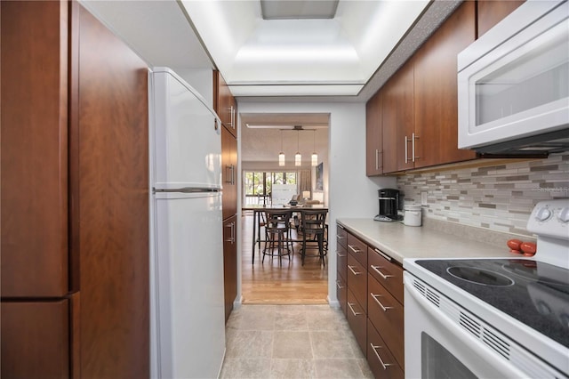 2220 Stickney Point Rd Unit 528, Sarasota, FL 34231 - kitchen featuring white appliances, decorative backsplash, and light countertops