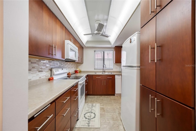 2220 Stickney Point Rd Unit 528, Sarasota, FL 34231 - kitchen with white appliances, a ceiling fan, decorative backsplash, light countertops, and a tray ceiling