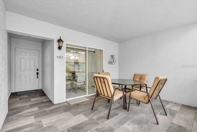6713 Stone River Rd Unit 101, Bradenton, FL 34203 - dining space with a textured wall and a textured ceiling