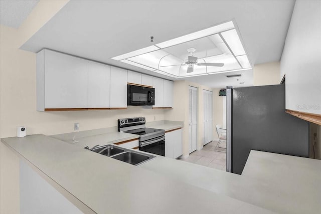 6713 Stone River Rd Unit 101, Bradenton, FL 34203 - kitchen with appliances with stainless steel finishes, a ceiling fan, white cabinets, light countertops, and light tile patterned floors