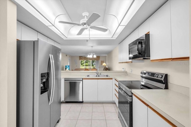 6713 Stone River Rd Unit 101, Bradenton, FL 34203 - kitchen featuring appliances with stainless steel finishes, light countertops, light tile patterned floors, white cabinets, and a ceiling fan