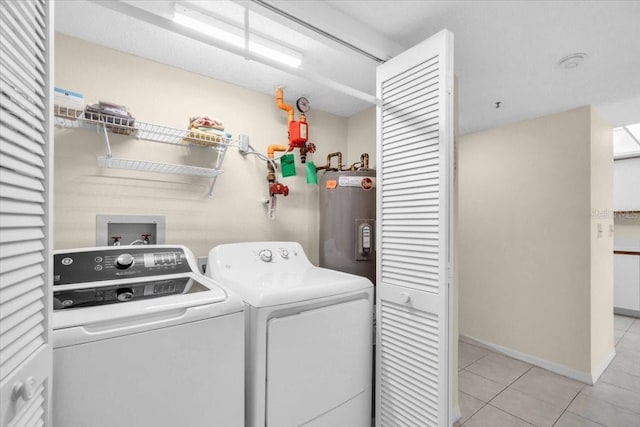 6713 Stone River Rd Unit 101, Bradenton, FL 34203 - laundry room featuring electric water heater, washing machine and dryer, and light tile patterned floors