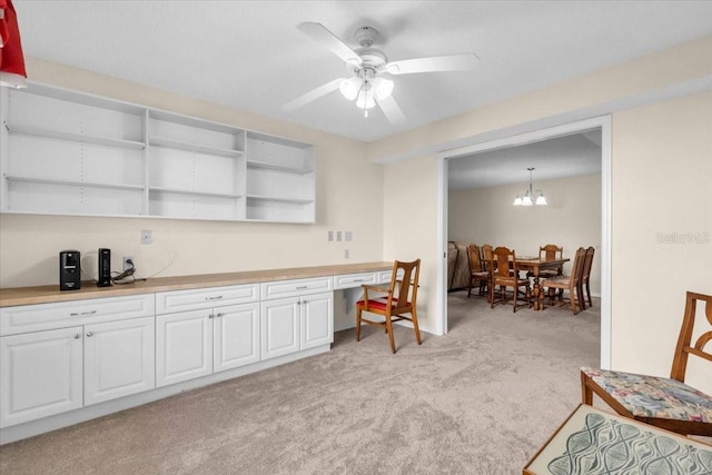 6713 Stone River Rd Unit 101, Bradenton, FL 34203 - kitchen featuring light colored carpet, white cabinetry, open shelves, and a ceiling fan
