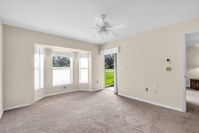 6713 Stone River Rd Unit 101, Bradenton, FL 34203 - carpeted spare room with plenty of natural light, ceiling fan, and a textured ceiling