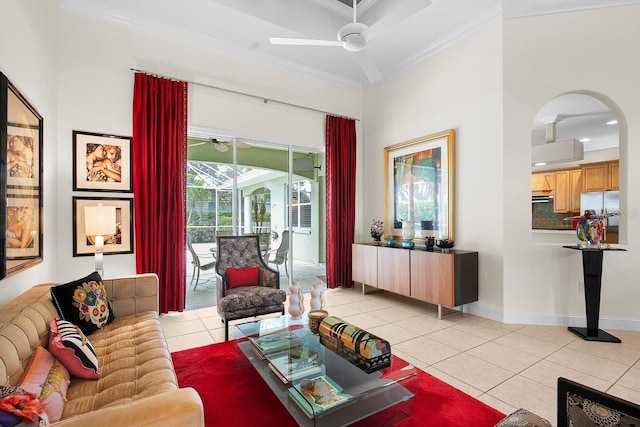 471 Park Trace Blvd, Osprey, FL 34229 - living room with ornamental molding, ceiling fan, light tile patterned flooring, arched walkways, and a towering ceiling