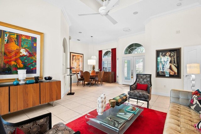 471 Park Trace Blvd, Osprey, FL 34229 - living room featuring light tile patterned floors, crown molding, a ceiling fan, and arched walkways
