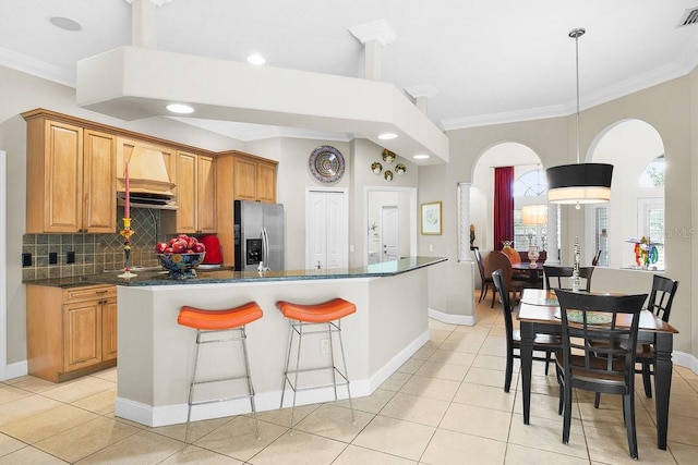 471 Park Trace Blvd, Osprey, FL 34229 - kitchen with stainless steel fridge, dark countertops, light tile patterned flooring, ornamental molding, and recessed lighting