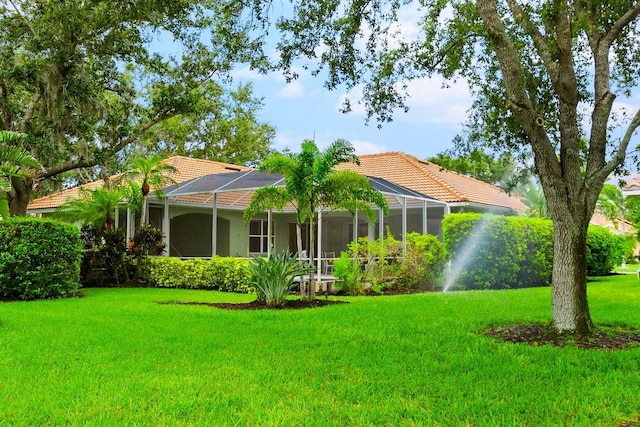 471 Park Trace Blvd, Osprey, FL 34229 - rear view of property featuring a tiled roof, a yard, and glass enclosure
