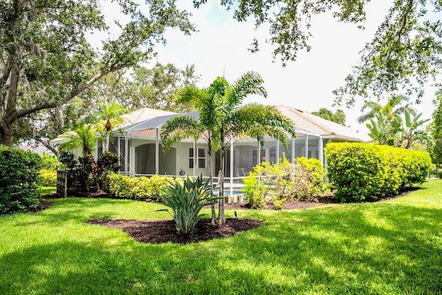 471 Park Trace Blvd, Osprey, FL 34229 - rear view of house with a yard and glass enclosure