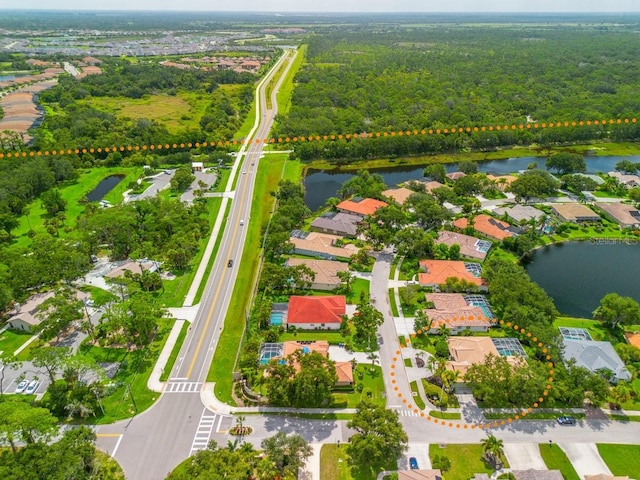 471 Park Trace Blvd, Osprey, FL 34229 - aerial perspective of suburban area with a nearby body of water and a heavily wooded area