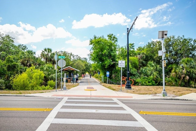 471 Park Trace Blvd, Osprey, FL 34229 - view of asphalt road with traffic signs, sidewalks, view of wooded area, and curbs