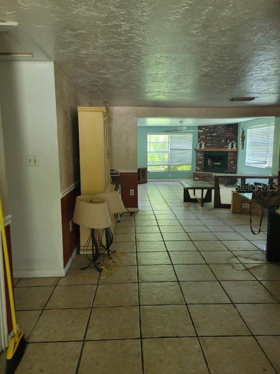 2532 Grand Cayman St, Sarasota, FL 34231 - living room featuring a fireplace and light tile patterned flooring