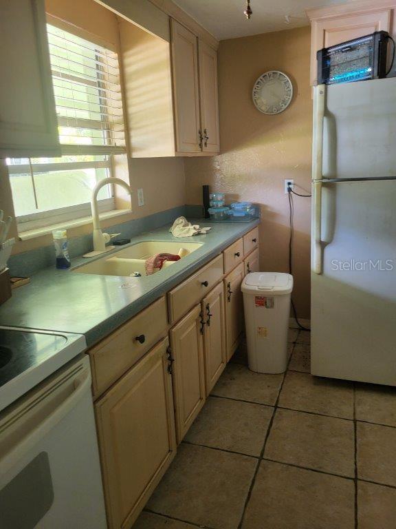 2532 Grand Cayman St, Sarasota, FL 34231 - kitchen featuring white appliances, light countertops, and light tile patterned floors