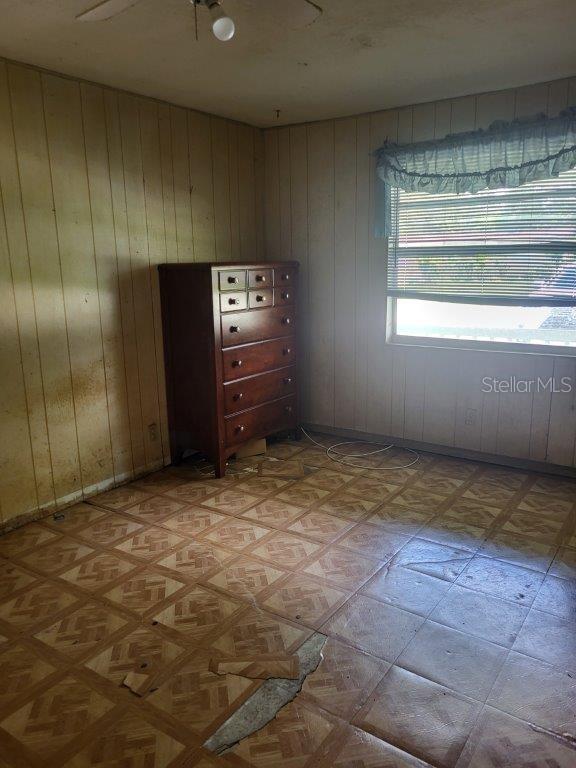 2532 Grand Cayman St, Sarasota, FL 34231 - empty room featuring wood walls and light flooring
