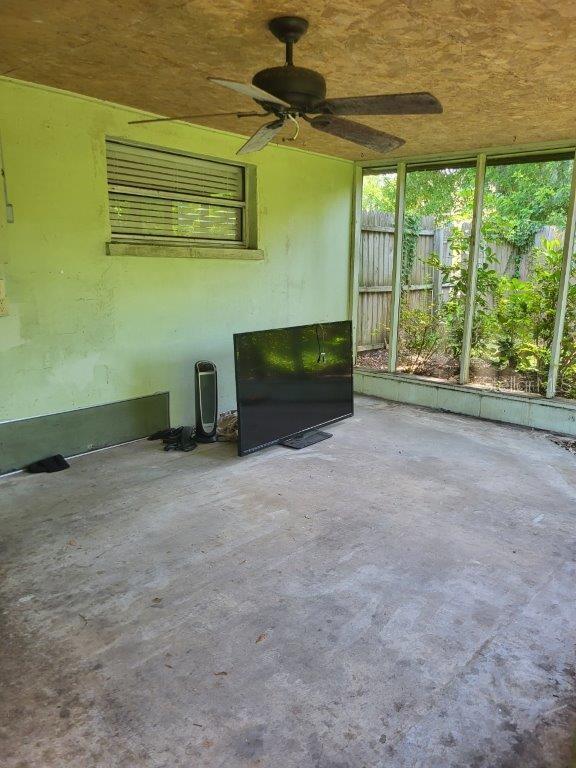 2532 Grand Cayman St, Sarasota, FL 34231 - unfurnished living room featuring concrete floors, a ceiling fan, and healthy amount of natural light