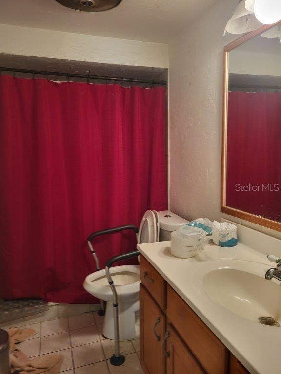 2532 Grand Cayman St, Sarasota, FL 34231 - bathroom featuring vanity, a textured wall, and tile patterned flooring