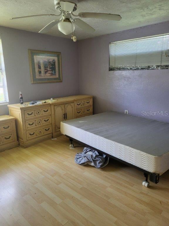 2532 Grand Cayman St, Sarasota, FL 34231 - bedroom featuring light wood-style flooring and a ceiling fan