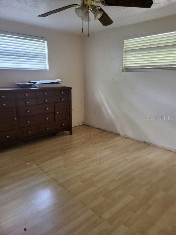 2532 Grand Cayman St, Sarasota, FL 34231 - unfurnished bedroom with light wood-style flooring and a ceiling fan