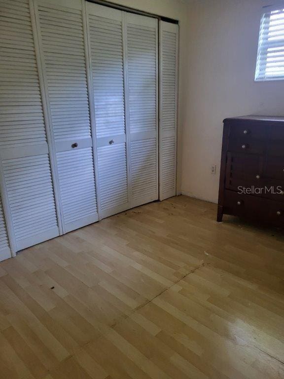 2532 Grand Cayman St, Sarasota, FL 34231 - unfurnished bedroom featuring light wood-style flooring and a closet