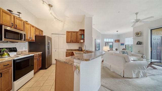 8397 38th Street Cir E Unit 306, Sarasota, FL 34243 - kitchen with appliances with stainless steel finishes, open shelves, a peninsula, and brown cabinetry