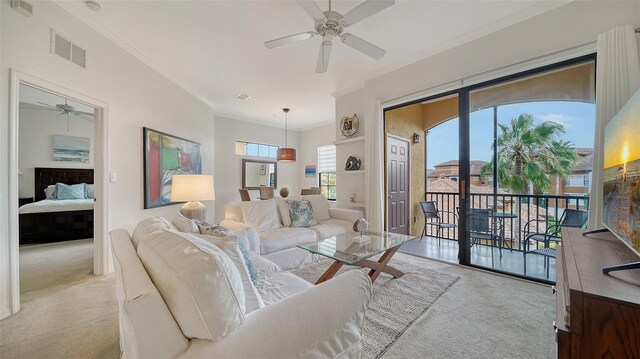 8397 38th Street Cir E Unit 306, Sarasota, FL 34243 - carpeted living room featuring ceiling fan and crown molding